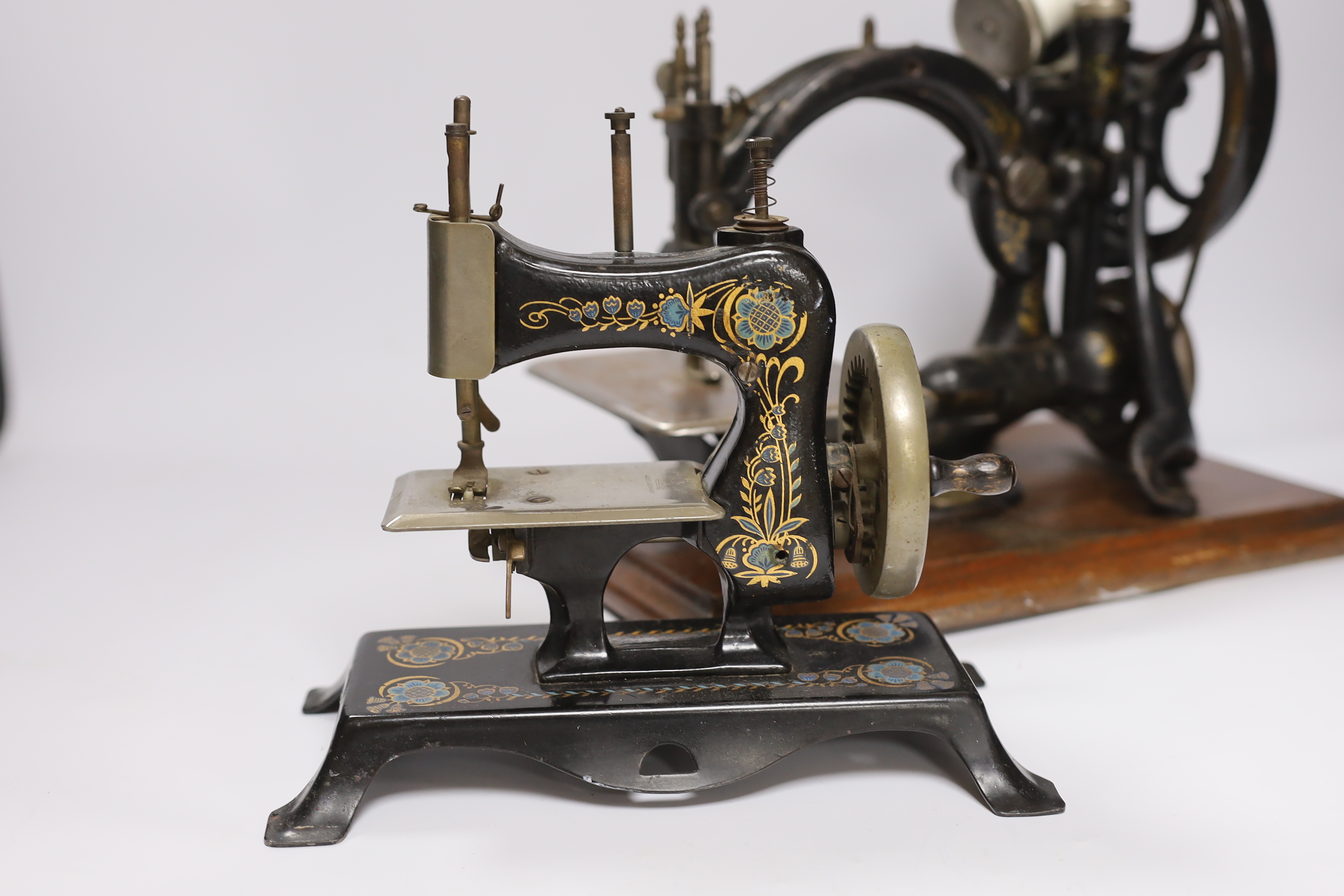 A Victorian Wilcox ad Gibbs sewing machine and a smaller sewing machine, 28cm high